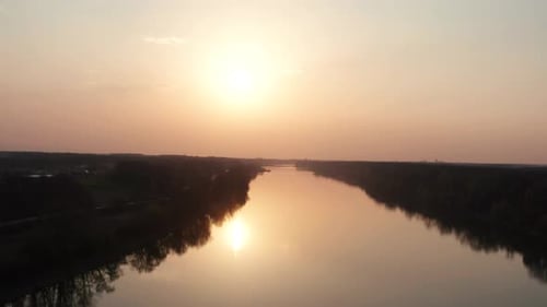 Drone flying over the river at evening sunset time. Beautiful nature wild life. River Sava in Bosnia