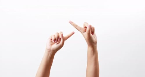 Close up of a woman's hand up and showing fingers crossed together to form a cross isolated on a whi