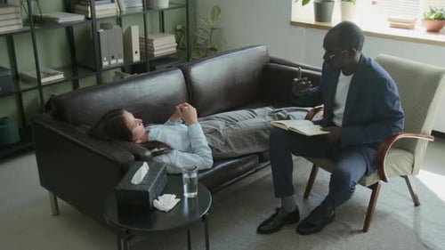 Male Counsellor Explaining Treatment Plan to Woman in Therapy Session