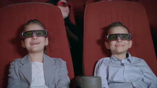 Children in 3D Glasses Watching Movie in Cinema. Excited Kids Watching Cartoon
