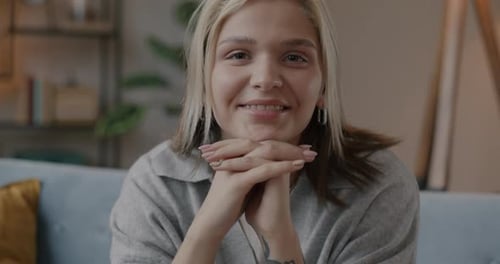 Woman Smiles Indoors on Couch