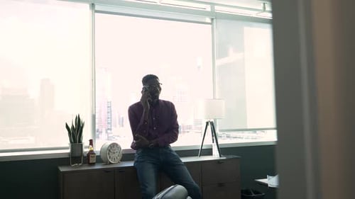 Young Businessman Talking on Smart Phone in Sunny Office Window Adult