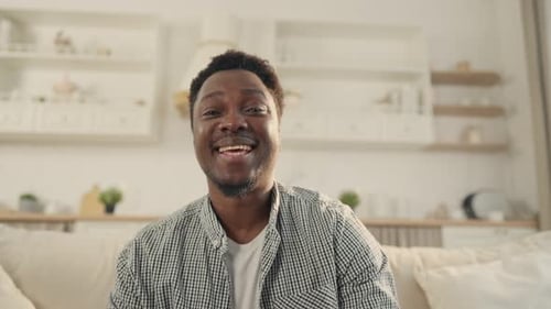 Smiling Man Talking to Camera in Bright Home