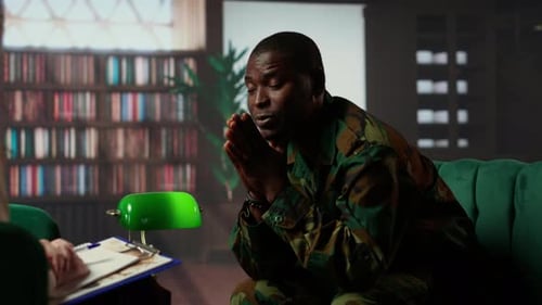 Worried Adult in Uniform Sits on Couch