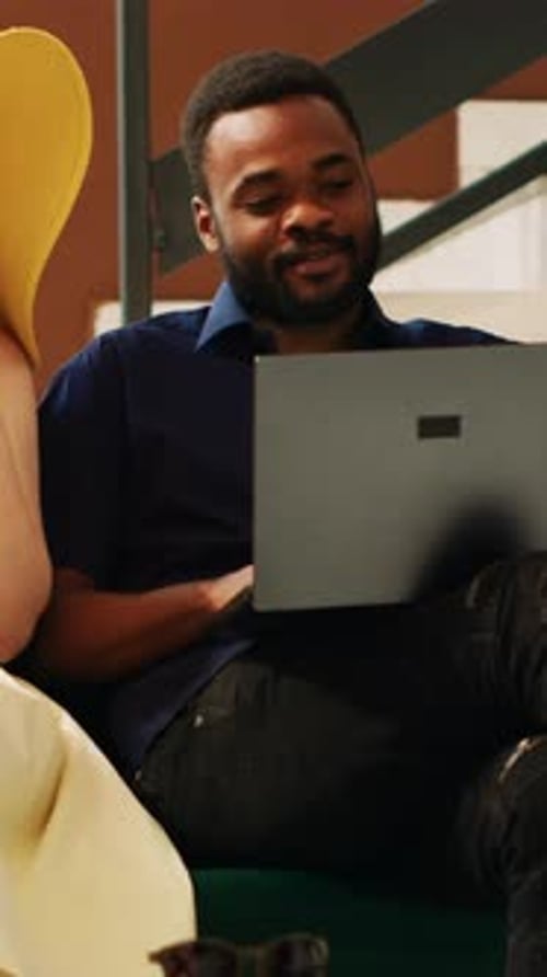 Vertical Video Couple Using Laptop in Hotel Lobby