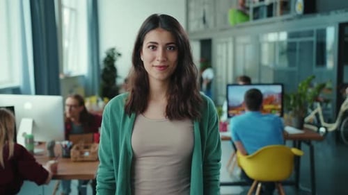 A Confident Woman in a Green Sweater Leads Colleagues Inspiring Teamwork