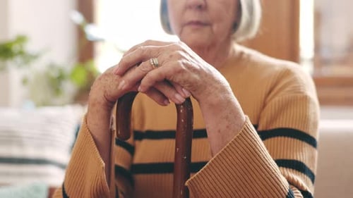 Close Up of Senior Woman Resting on Cane