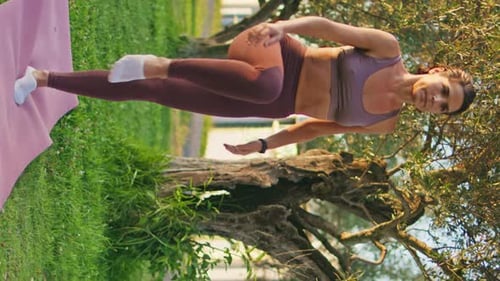 Yoga Model Practicing Asana at Sunny Park Vertical Woman Performing Stretching