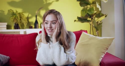 Excited Woman Video Calling on Smartphone at Home