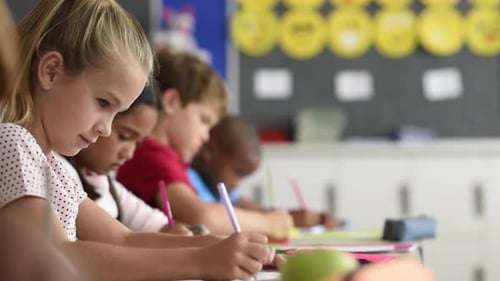 Focused Children Studying at Desks in Classroom Setting