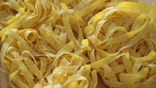Close Up of Raw Fresh Pasta Rotate on Board Fettuccine Tagliatelle Pasta
