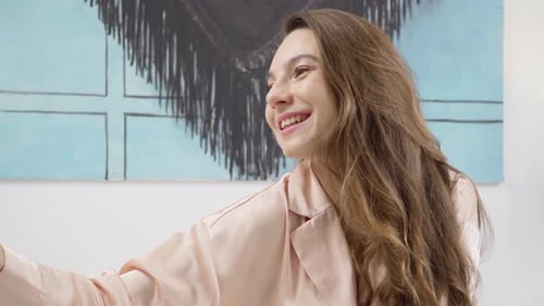 Smiling Woman Poses in Silky Pajamas at Home