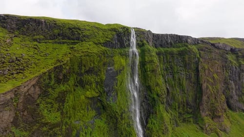 Aerial view of lush waterfall cascade, Iceland.