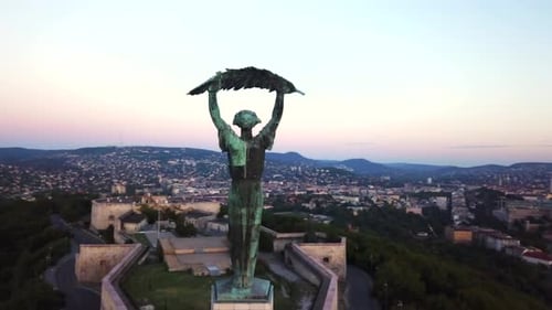 Budapest liberty statue and view of the early sun over the city