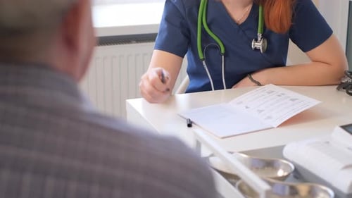 Doctor Consults with Patient, Writing on Chart