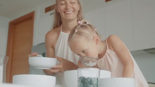 Mother and Daughter Baking Together in Kitchen