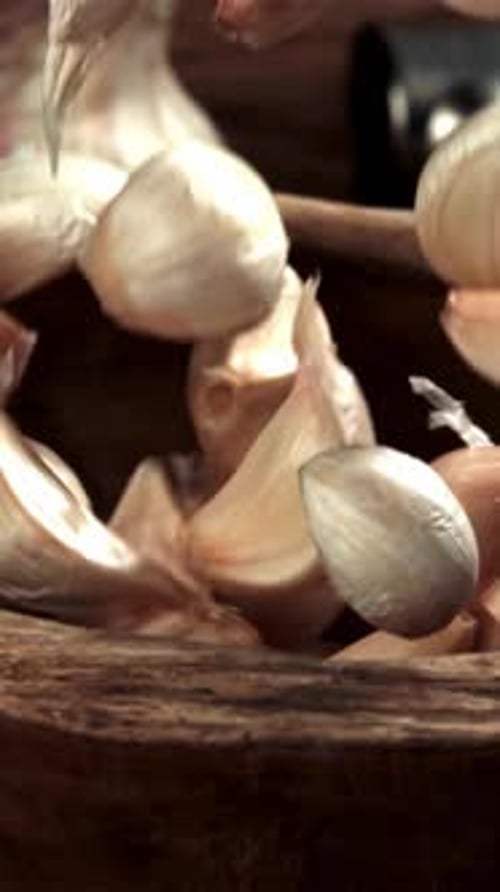 Garlic Falls Into a Wooden Plate Filmed on a Highspeed Camera at 1000 Fps