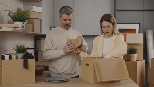 Family Owners Unpaks Things From the Box at New Home
