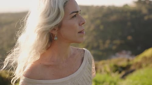 Woman with Gray Hair in Nature at Sunset