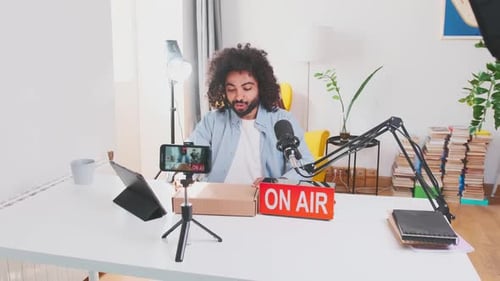 Young Adult Making a Technology Podcast at Home