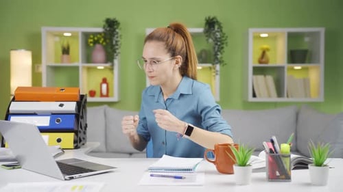 Woman Celebrating Success While Working at Computer