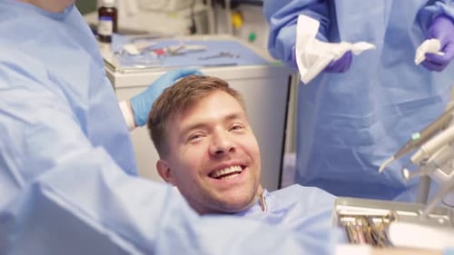 Man in Dental Office Gives Thumbs Up