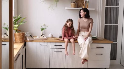 Mother and Daughter Sitting in the Kitchen