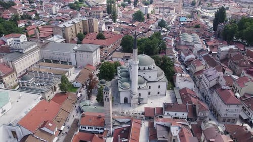 Muslim mosque with minaret in balkan city Sarajevo, scenic aerial orbit