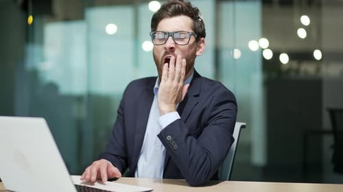 Bored business man in office Sleeping sleepy yawning boredom at workplace indoors Tired Exhausted