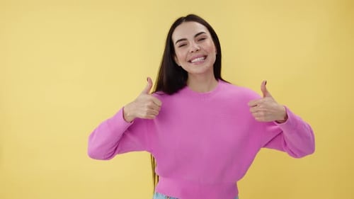 Woman Gives Thumbs Up with a Bright Smile