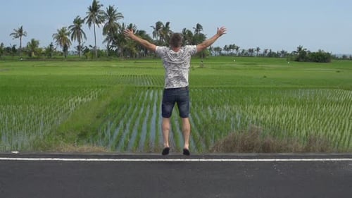 Happy Man Jumping Near Rice Field Achievement