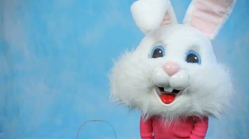 Child Wearing Easter Bunny Suit Waving Hello