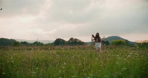 A Happy Woman Walks Through A Meadow
