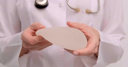 Doctor Examines Silicone Breast Implant Close Up