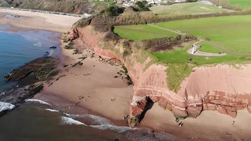 Aerial panning left shot of the cliffs at Orcombe Point Exmouth Devon England