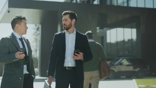Businessmen Talking Outside Modern Office Building