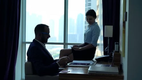 Young Businesspeople Talking and Using Tablet Computer in Office Adult