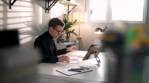 Young Adult Man Designs on Tablet in Modern Home