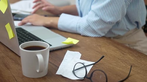 Woman Calculates Domestic Expenses Involved in Financial Paperwork Summarizing Utility Bills