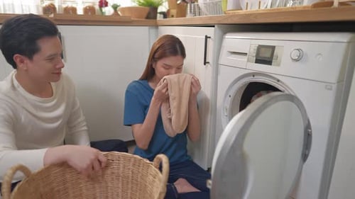 Young Couple Doing Laundry Together at Home