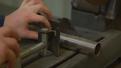 Close up shot of worker's hand tightening iron stick for cutting