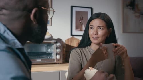 Couple Talking and Eating Breakfast Together
