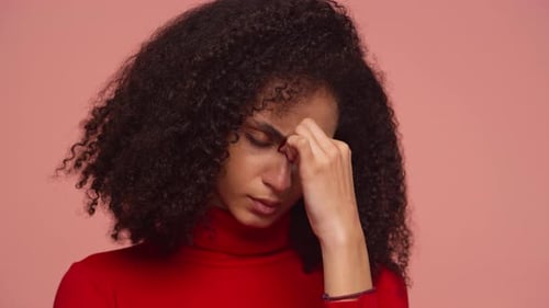 Young Adult Woman with Headache Touching Nose