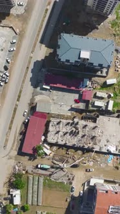 Vertical Video New Construction Begins with Builders and Heavy Machines Preparing the Foundation