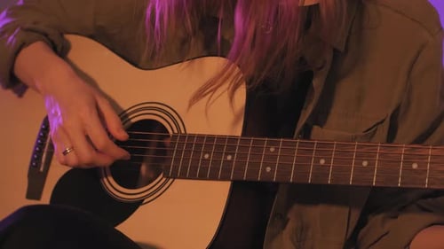 Woman Plays Acoustic Guitar Close Up Indoors