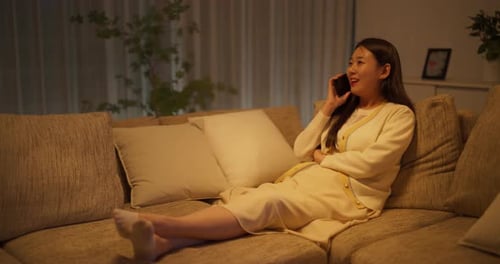 Woman Relaxing on Couch Talking on Phone