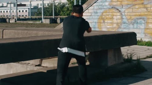 Man Performs Acrobatic Flips in an Urban Park