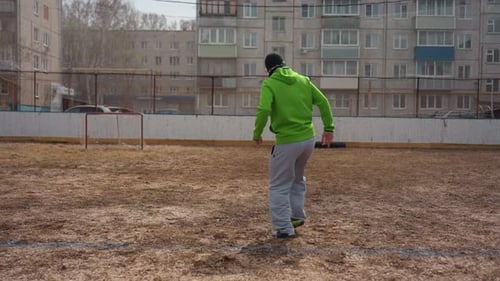 Man Juggling Soccer Ball Outdoors in Urban Environment