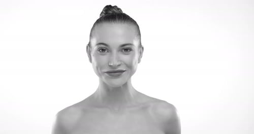 Young Woman with Hair in Bun Posing in Studio