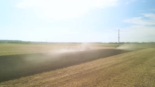 Tractors plowing the field in Ukraine